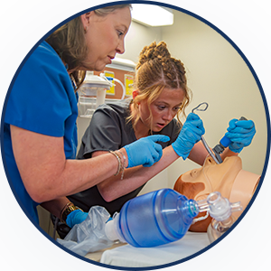 nursing students practicing intubation on dummy