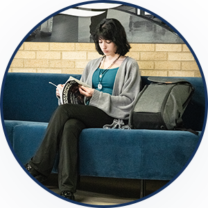 student studying in college lounge area