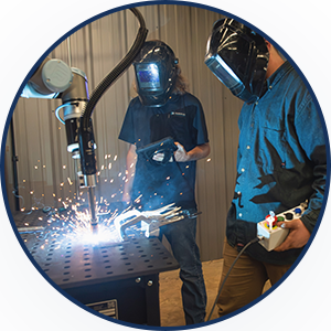 students observe robotic welding